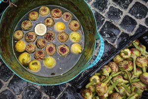 Trimmed artichokes in lemon water