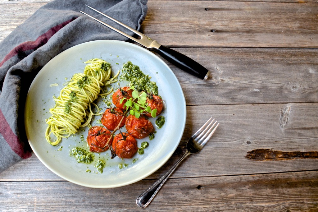 Pasta with pesto and roasted tomatoes on the vine